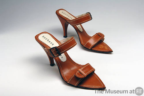 Pair of tan leather high heel sandals with white stitching, two straps and pointed toe