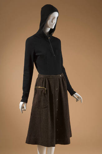 Black fitted long sleeve blouse with hood styled with brown knee length skirt with coin purse s…