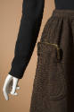Detail of brown skirt with pouch pocket with snap closure