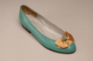Green leather pump with orange satin ribbon bow and low heel