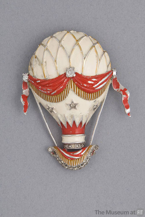 Brooch of white hot air balloon with red sash