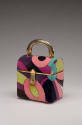 Box style velvet handbag with pink, blue, purple, green abstract design and gold handle 