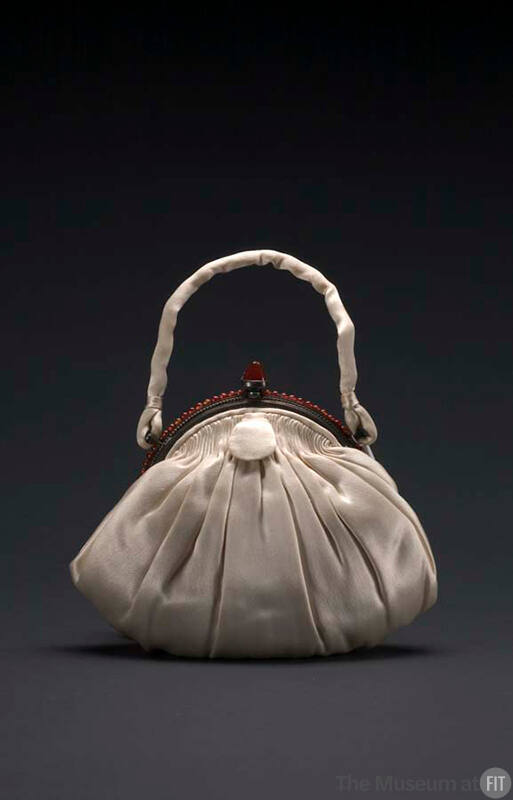 Small ivory shell shaped evening pouch with self handle