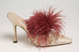 Off-white high heel mule with red and green berry brocade design and tuft of dark red feathers …