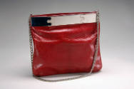 Red leather shoulder bag, square shaped pouch, with silver chain strap and silver top bar with …