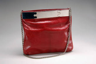 Red leather shoulder bag, square shaped pouch, with silver chain strap and silver top bar with …