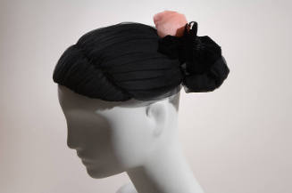 Black hat in chignon hair style with pink rose and black flower on center back