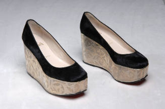 Black high platform pumps with unit sole covered with silver metal engraved with floral scrollw…