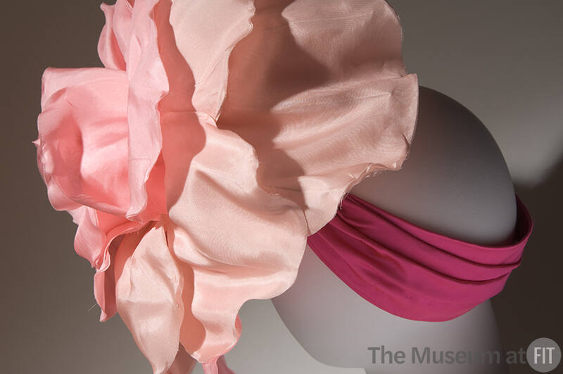 Oversize pink rose hat on pleated magenta band