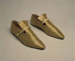 Alternate view of gold metallic flat shoes with a darker background  