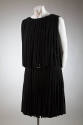 Black fringed sleeveless mini-dress showing rhinestone belt buckle at waist