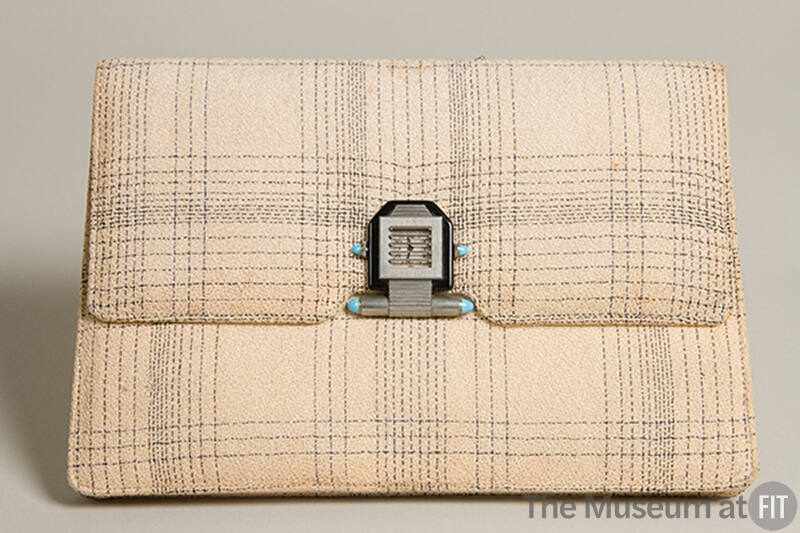 Cream clutch envelope style handbag with black plaid pattern and large silver clasp
