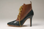 Tan and hunter green hybrid boots with sharply pointed toe and shaped, spike heel