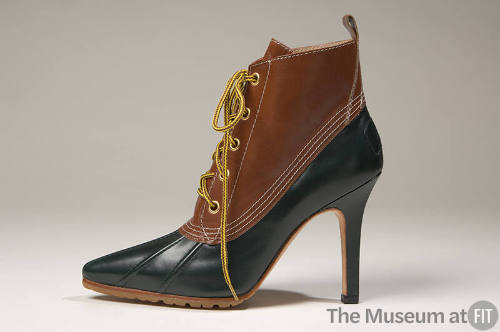 Tan and hunter green hybrid boots with sharply pointed toe and shaped, spike heel