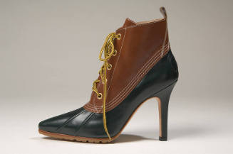 Tan and hunter green hybrid boots with sharply pointed toe and shaped, spike heel