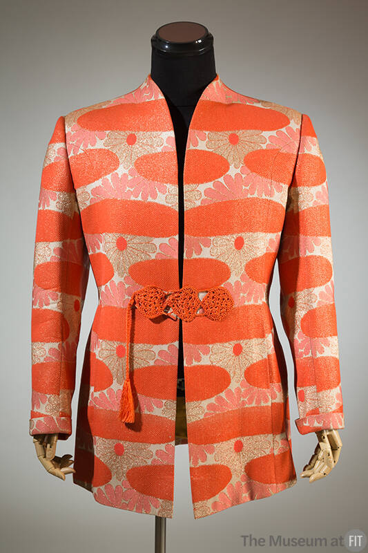 Man’s orange, beige and metallic gold floral pattern collarless jacket with orange tassel and c…