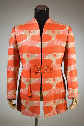 Man’s orange, beige and metallic gold floral pattern collarless jacket with orange tassel and c…