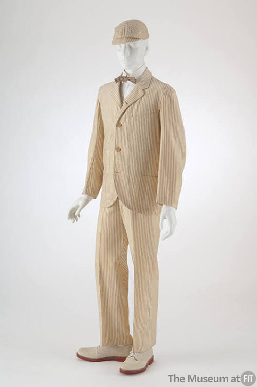 Man’s off-white with navy blue pinstripe suit of single-breasted jacket, matching pants and hat…