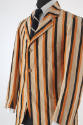 ¾ view of man’s beige, orange and black vertical striped blazer with notched lapels, three butt…