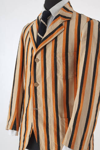 ¾ view of man’s beige, orange and black vertical striped blazer with notched lapels, three butt…