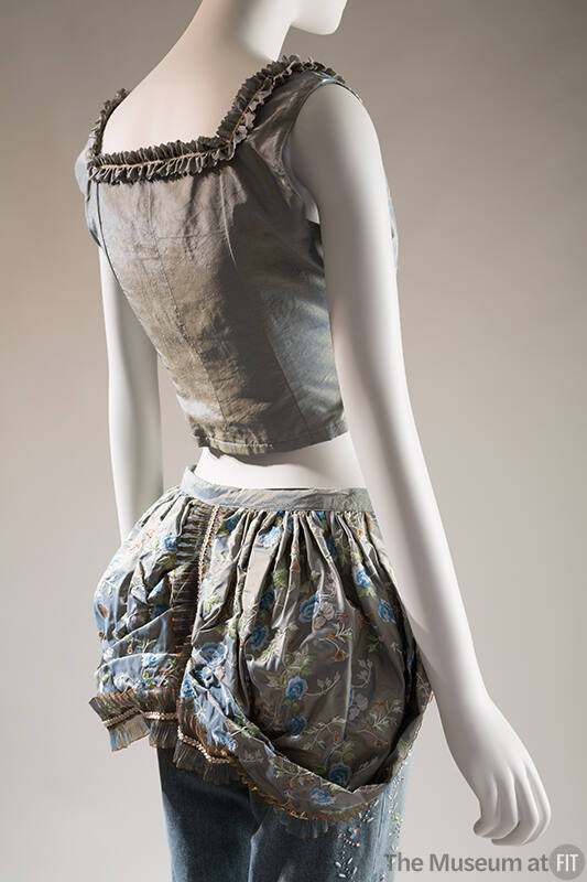 BAck view of blue and gold silk bustier with lace trim, matching floral bustle over beaded deni…