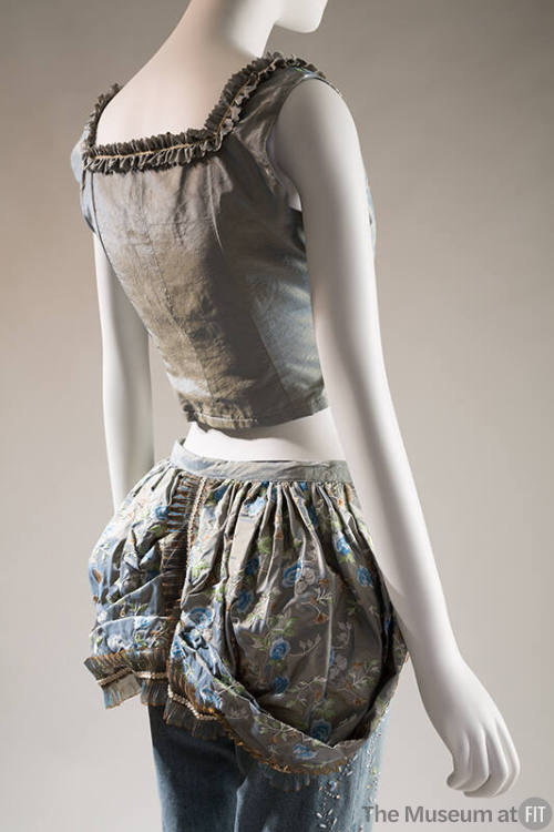 BAck view of blue and gold silk bustier with lace trim, matching floral bustle over beaded deni…