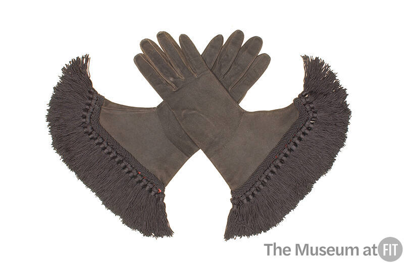 Pair of black gloves with braid and long tassel fringe at cuff