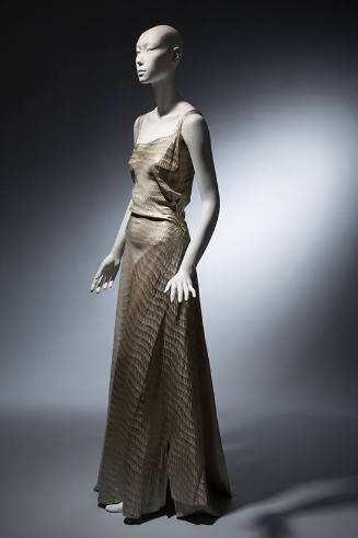 Light blue floor length evening dress with gold horizontal sawtooth stripes, asymmetrical bodic…