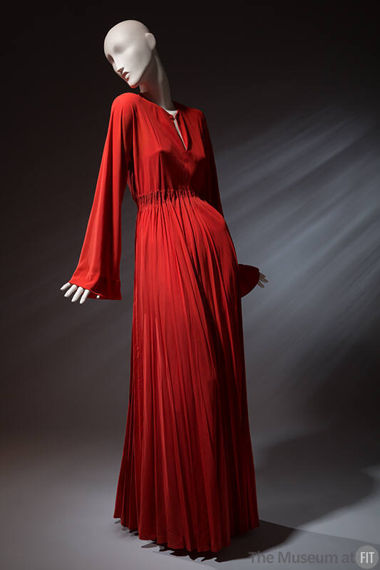 Orange chemise gown with center front slit, long bell kimono sleeves, elastic waist and pleated…