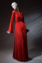 Orange chemise gown with center front slit, long bell kimono sleeves, elastic waist and pleated…