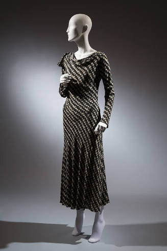 Fitted calf-length day dress in a black and white patterned diagonal stripe with a cowl neck an…