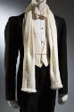 Detail of black tuxedo with off-white button front shirt, three button vest, bowtie and scarf