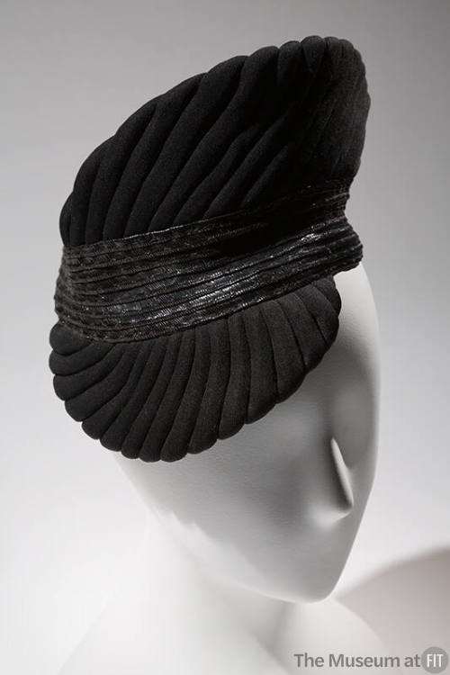 Black trapunto quilt stitched cocktail hat with pointed crown and visor