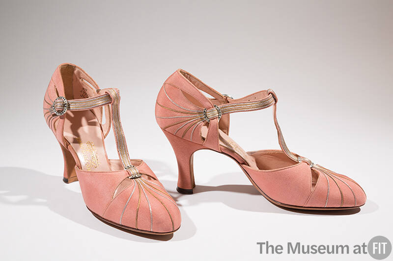 Pair of pink T-strap evening shoes with silver and gold piping running from toes to T-strap and…