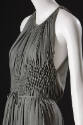 Detail view of grey evening gown showing diamond shaped smocking panel on midriff and drawstrin…