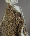 detail of one shoulder, asymmetrical leapord print dress with matching feather trimmed stole