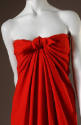 Strapless, draped red dress with tie front that creates folded pleats
