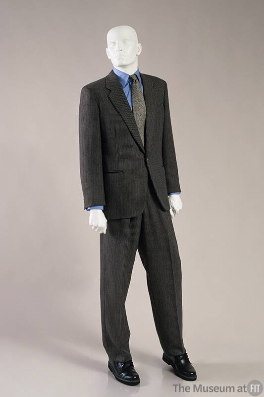 Man’s brown, tan and grey tweed single breasted suit dressed with blue oxford shirt, grey tie a…