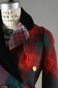 Detail shot of suit  jacket collar and shoulder  in various red, green, white plaids with black…
