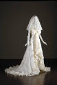 Alternate view of off-white wedding dress with large bow bodice and ruffled trim down front and…