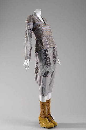 Grey and beige top beaded with tile design over grey knit dress with rust paisley designs over …