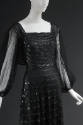 Detail of black tulle dress with horizontal rows of black sequin stripes, square neckline, long…