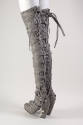Grey high heel thigh high boots with crisscrossing leather straps that tie at top, zippered bac…