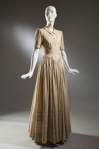 Cream full-length dress with corded pinstripes alternating with navy blue; fitted torso and ful…