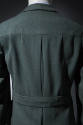 Detail of back of green and blue tweed jacket showing banded waist and center pleat 