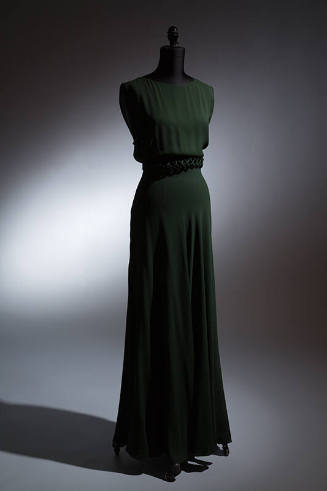 Dark green sleeveless floor length dress with lattice design piping at waist