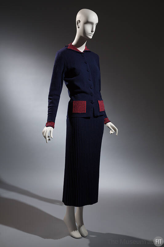 Blue knit hip length button front jacket with red ribbed collar, cuffs and pockets, blue knit a…