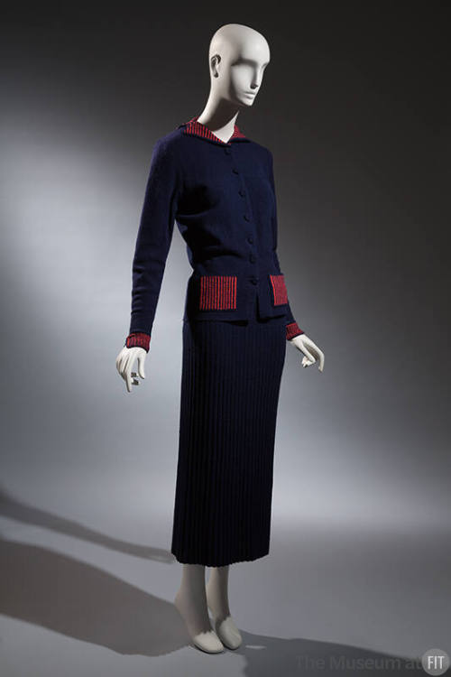 Blue knit hip length button front jacket with red ribbed collar, cuffs and pockets, blue knit a…