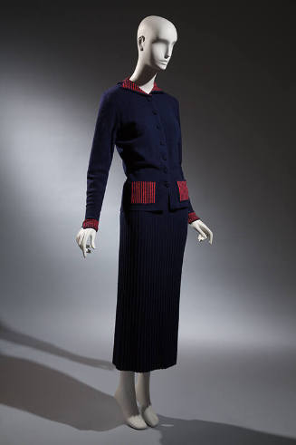 Blue knit hip length button front jacket with red ribbed collar, cuffs and pockets, blue knit a…