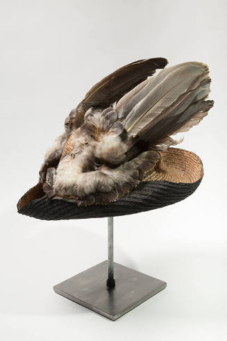 Blue/grey woven straw tricorne style hat turned up at sides to reveal black underside and wing …
